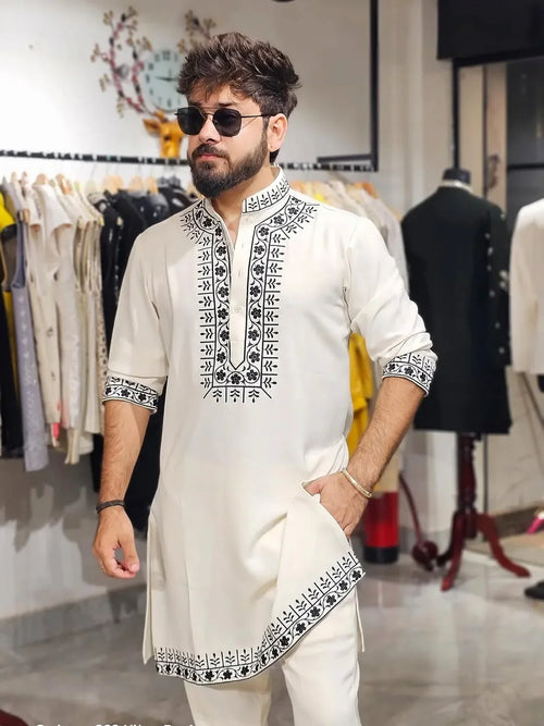 White embroidery kurta with black thread work and matching kurta pajama set by pravohammenskurta, detailed traditional design.
